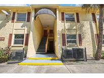 Building exterior with stairs, awning, and red shutters at 7585 Abonado Rd, Tampa, FL 33615