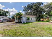 Newly renovated home with gravel driveway and palm trees at 2409 S 70Th St, Tampa, FL 33619