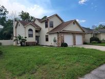 Two-story house with a two-car garage at 10908 Claymont Dr, New Port Richey, FL 34654