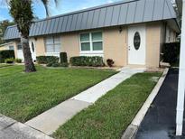 Brick building with landscaping and walkway at 11920 Boynton Ln # 11920, New Port Richey, FL 34654