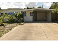House exterior showcasing a carport and well-maintained landscaping at 5163 Tangelo Dr, New Port Richey, FL 34652