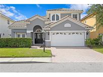 Two story house with gray siding, white garage door, and landscaping at 10616 Cape Hatteras Dr, Tampa, FL 33615