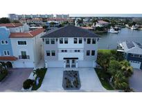 Modern three-story waterfront home with attached two-car garage at 160 174Th Terrace E Dr # A, Redington Shores, FL 33708