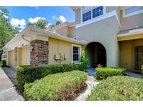 Townhouse exterior with two-car garage and landscaping at 8125 Stone Path Way, Tampa, FL 33647