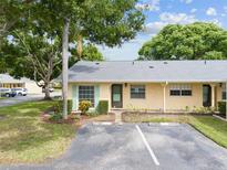 Exterior view of a yellow house with teal shutters at 2465 Northside Dr # 701, Clearwater, FL 33761