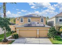 Two-story house with solar panels and a two-car garage at 20270 Merry Oak Ave, Tampa, FL 33647