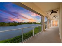Enjoy colorful sunsets over the lake from this spacious balcony with glass railings and ceiling fans at 43 Bayview S Ct # A, St Petersburg, FL 33711