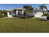 Single-story home with well-maintained landscaping at 2451 E Del Webb Blvd, Sun City Center, FL 33573