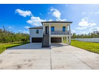 Modern two-story home with attached garage and metal staircase at 2316 S 46Th St, Tampa, FL 33619