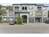 Exterior of a two-story building with gray and blue accents at 13113 Sanctuary Cove Dr # 104, Temple Terrace, FL 33637
