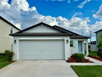 Newly constructed one-story home with a two-car garage and landscaped yard at 31836 Barrel Wave Way, Wesley Chapel, FL 33545