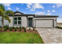 Charming single-story home featuring a well-manicured lawn and paved driveway at 13715 Brookside Haven St, Riverview, FL 33578