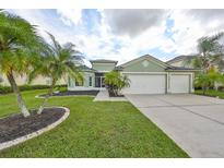 Charming two-story home with a two-car garage and mature landscaping at 10926 Sailbrooke Dr, Riverview, FL 33579