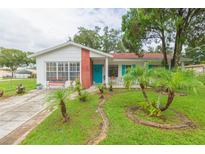 Charming ranch-style home with a brick facade and well-manicured lawn at 6515 Los Altos Way, Tampa, FL 33634