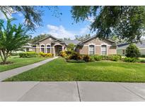 Two-story house with a landscaped yard and walkway at 15212 Kestrelrise Dr, Lithia, FL 33547