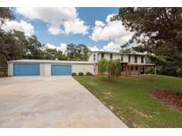 Two-story home with detached garage and covered patio at 12805 Flint Creek Rd, Thonotosassa, FL 33592
