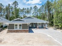 Charming single-story home with a paved driveway and stone accents at 4729 Majestic Hills Loop, Brooksville, FL 34601