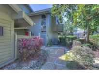 Landscaped walkway leading to the condo's entrance at 5333 Cobblestone Ct, Wesley Chapel, FL 33543