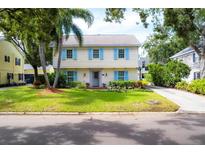 Charming two-story home with light yellow siding and blue shutters at 1229 S Roxmere Rd, Tampa, FL 33629