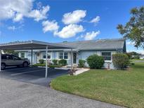 Light blue condo with carport and small, well maintained lawn at 216 Gloucester Blvd # 216, Sun City Center, FL 33573