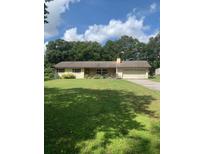 Ranch style home with mature landscaping and a spacious yard at 2705 Ranch Rd, Dover, FL 33527