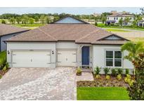 Charming single-story home featuring a paver driveway and a two-car garage at 13720 Brookside Haven St, Riverview, FL 33578