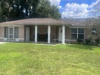 Single-story house with covered porch and green lawn at 38638 Patti Ln, Dade City, FL 33523