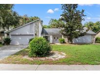 Two-story house with stone accents and a neatly kept lawn at 15904 Nottinghill Dr, Lutz, FL 33548