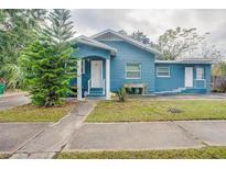Quaint blue house with a well-maintained lawn and walkway at 2908 W Spruce St, Tampa, FL 33607