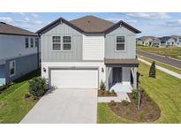 Charming two-story home features a two-car garage and well-manicured lawn at 6240 Golden Beach Dr, Apollo Beach, FL 33572
