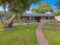 1-story home with landscaped yard and walkway at 1756 Ashton Abbey Rd, Clearwater, FL 33755