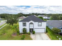 Two-story house with a gray roof, white exterior, and a landscaped yard at 2746 Heathgate Way, Land O Lakes, FL 34638