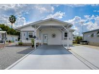 Single-story home with carport and landscaped yard at 4976 Britni Way, Zephyrhills, FL 33541