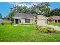 One-story home with beige siding, stone accents, and a two-car garage at 2039 Shadow Pine Dr, Brandon, FL 33511