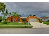 Charming single-story home with a two-car garage at 7906 Willow Brook Ct, Hudson, FL 34667