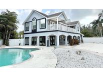 Charming two-story home featuring a pool and white rock landscaping at 6710 Myrna Dr, Tampa, FL 33619