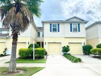 Two-story townhome with a charming facade and a two-car garage at 10823 Verawood Dr, Riverview, FL 33579