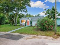 Charming bungalow with a pink door and well-manicured lawn at 3805 14Th S Ave, St Petersburg, FL 33711