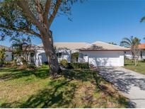 White single-story house with a two-car garage and mature landscaping at 1973 Hawaii Ne Ave, St Petersburg, FL 33703
