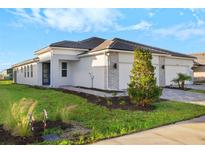 Two-story home with gray stone accents and a two-car garage at 11269 Boundless Ter, Venice, FL 34293