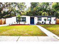 Ranch style home with modern exterior and landscaping at 1923 E Henry St, Tampa, FL 33610