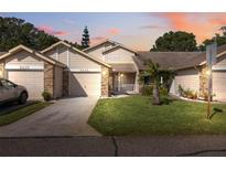 Two-story townhome with attached garage and well-maintained landscaping at 6435 Thicket Trl, New Port Richey, FL 34653