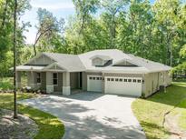 Beautiful single-story home with a three-car garage and charming curb appeal at 22426 Golden Retriever Ln, Brooksville, FL 34601