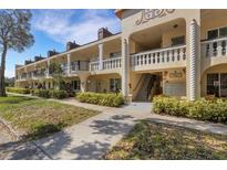 Exterior view of condo building with lush landscaping and walkway at 2298 Netherlands Dr # 4, Clearwater, FL 33763