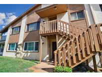 Condo building exterior with wooden staircase and landscaping at 4028 Davit Dr # 4028, New Port Richey, FL 34652
