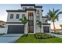 Stunning, modern home with a two-car garage and beautiful landscaping at 2832 W Vina Del Mar Blvd, St Pete Beach, FL 33706