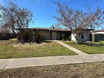 Single-story home with well-maintained lawn and walkway at 620 Dalton Blvd, Port Charlotte, FL 33952