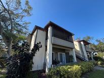 Two-story condo building with screened balcony, lush landscaping and a tranquil setting at 10263 Gandy N Blvd # 2114, St Petersburg, FL 33702