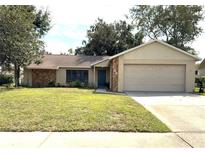 One-story home with attached garage and stone accents at 7140 Orchid Lake Rd, New Port Richey, FL 34653