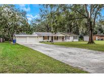 Charming ranch house with a two-car garage and spacious yard at 15901 Manning Dr, Tampa, FL 33613